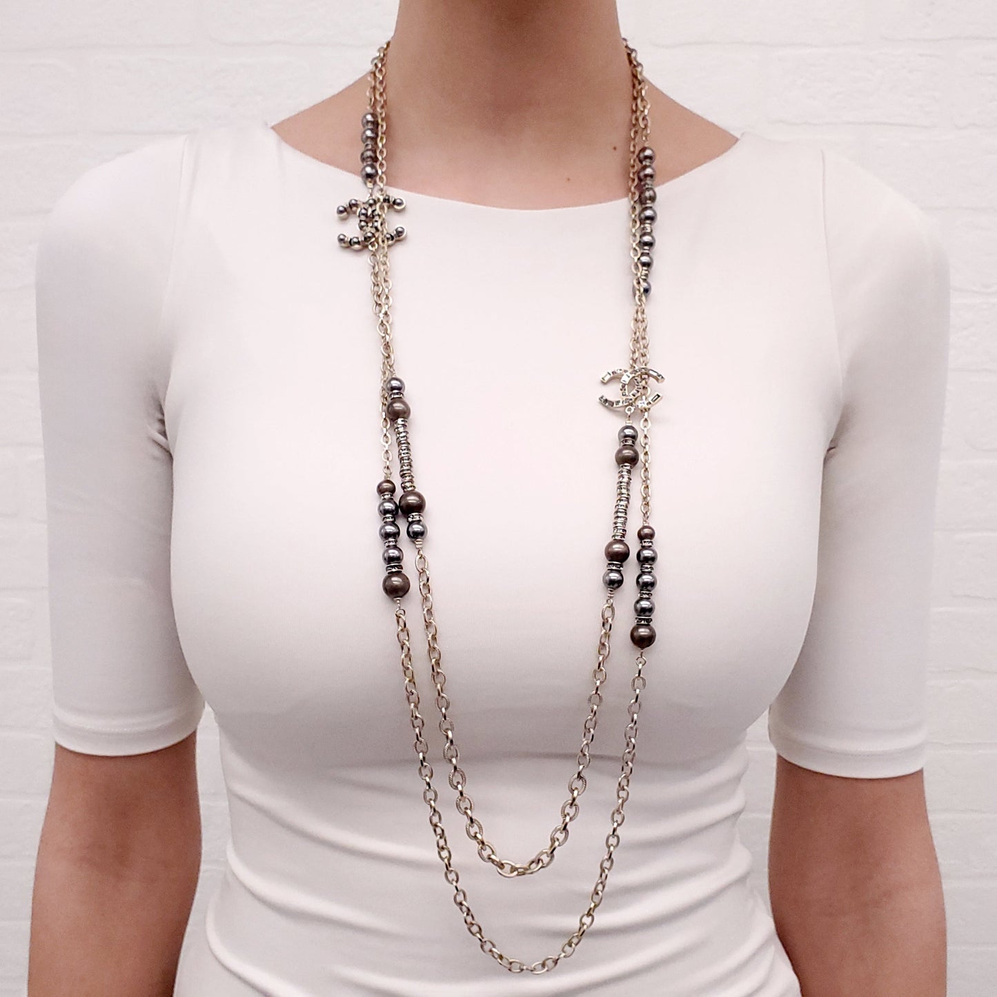 CHANEL GOLD, BRONZE, AND GREY LAYERED PEARL NECKLACE WITH CRYSTAL LOGOS